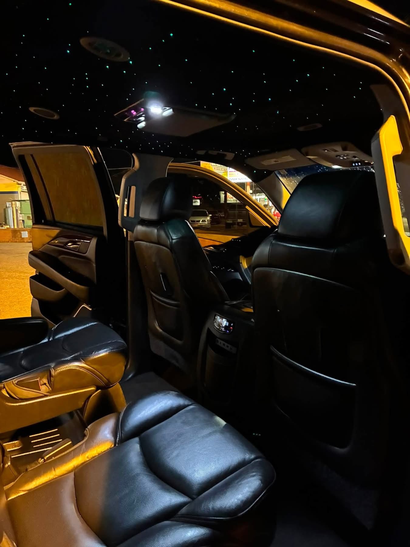 BLACK CADILLAC ESCALADE WITH STARS IN CEILING